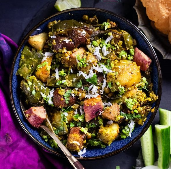 A hearty winter bowl of Lilva Tuver nu Shaak—fresh green tuver, seasonal veggies, and warm Gujarati spices coming together in a beloved cold-season ritual.