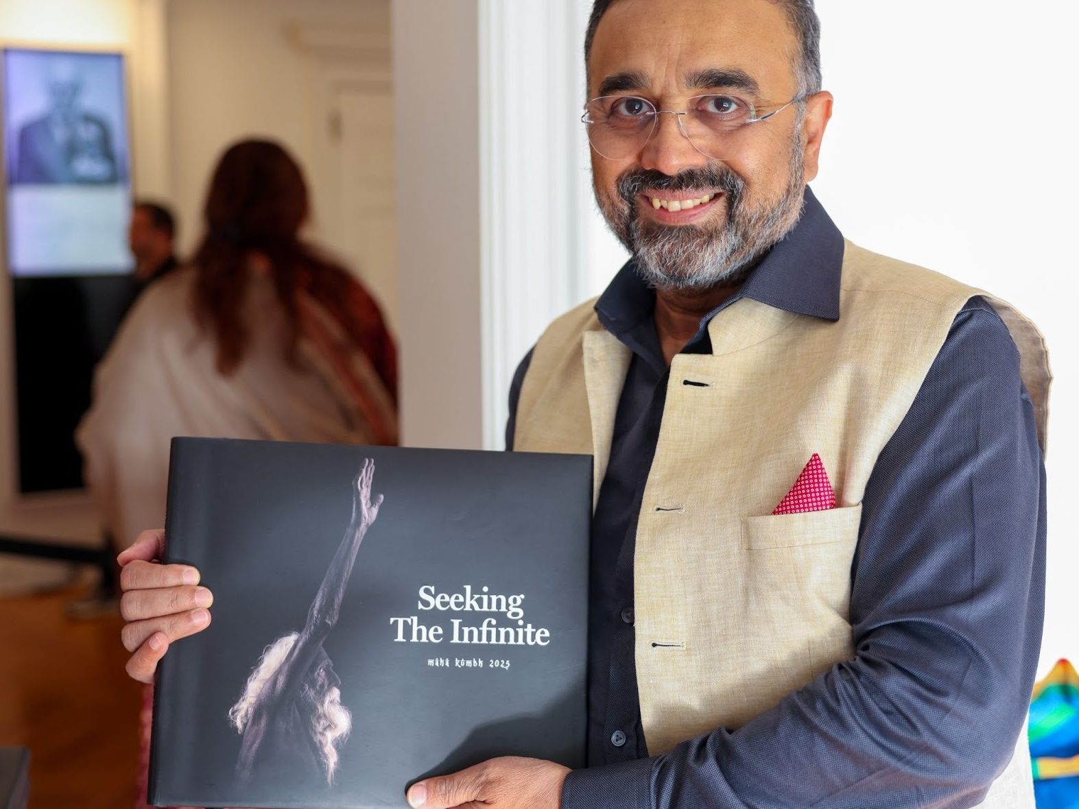 Author Yakub Mathew holding a copy of his coffee table book