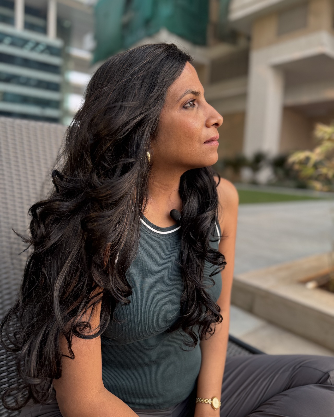 The author, a young lady, in a reflective mood in front of an apartment building